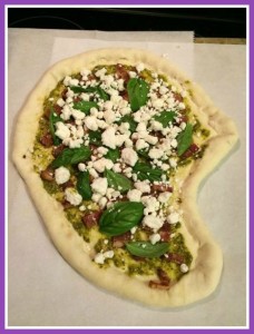 I like mine with pesto, fresh basil, goat cheese crumbles, and bacon.